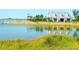 The community offers a tranquil exterior view of a lake and clubhouse at 8077 Sandstar Way, Sarasota, FL 34240