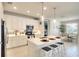 Bright, modern kitchen with quartz countertops, stainless steel appliances, and a breakfast bar at 8077 Sandstar Way, Sarasota, FL 34240