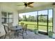 Screened lanai with patio table offering views of the manicured backyard and mature landscaping at 8077 Sandstar Way, Sarasota, FL 34240