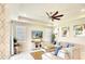 Spacious living room with tile flooring, neutral walls, a ceiling fan, and plenty of natural light at 8077 Sandstar Way, Sarasota, FL 34240