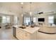 Open-concept space showcases a kitchen island, living room and breakfast nook, promoting seamless living at 8077 Sandstar Way, Sarasota, FL 34240