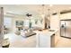 Contemporary living area flows from kitchen island, offering integrated living and entertaining space at 8077 Sandstar Way, Sarasota, FL 34240