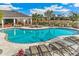 Inviting community pool with sun loungers and landscaping, perfect for relaxing in the sun at 833 157Th E Ct, Bradenton, FL 34212