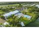 Aerial view of the community pool, spa, and other amenities, surrounded by lush landscaping at 8531 Imperial Cir, Palmetto, FL 34221