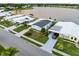 Aerial view of the home with a well-kept lawn, mature landscaping, and convenient carport at 8531 Imperial Cir, Palmetto, FL 34221