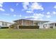 Relax on the screened-in porch overlooking the manicured backyard with a beautiful flower bush at 8531 Imperial Cir, Palmetto, FL 34221