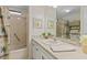 Cozy bathroom featuring a shower, vanity with sink, and beach-themed decorations at 8531 Imperial Cir, Palmetto, FL 34221