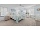 Spacious bedroom with carpeted floors, a ceiling fan, and multiple windows for ample natural light at 8531 Imperial Cir, Palmetto, FL 34221