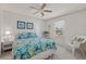 Bright bedroom featuring a ceiling fan, comfortable bed, and a window with blinds at 8531 Imperial Cir, Palmetto, FL 34221