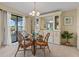 Light-filled dining area with rattan furniture and built-in serving station with lake views at 8531 Imperial Cir, Palmetto, FL 34221