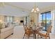 Bright dining area with rattan table set and views of the water from sliding glass doors at 8531 Imperial Cir, Palmetto, FL 34221