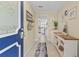 Inviting entryway with blue front door and decorative accents, opening to the kitchen at 8531 Imperial Cir, Palmetto, FL 34221