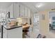 Efficient kitchen design includes a built-in desk area and modern appliances with sightlines to the main bedroom at 8531 Imperial Cir, Palmetto, FL 34221