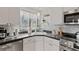 Bright kitchen features stainless steel appliances, white cabinets, and decorative tile backsplash at 8531 Imperial Cir, Palmetto, FL 34221