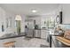 Bright kitchen with stainless steel appliances, white cabinets, modern lighting, and tile flooring at 8531 Imperial Cir, Palmetto, FL 34221