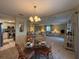 Bright living room featuring a dining table, with kitchen access, and comfortable furniture arrangement at 8531 Imperial Cir, Palmetto, FL 34221