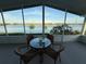 Relaxing screened patio overlooking a serene lake view with palm trees at 8531 Imperial Cir, Palmetto, FL 34221