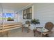 Relaxing covered porch featuring two Adirondack chairs with decorative pillows and decorative palm at 8531 Imperial Cir, Palmetto, FL 34221