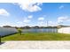 Beautiful backyard featuring a pond view, a white fence, and a well-kept lawn at 8656 40Th E Cir, Palmetto, FL 34221