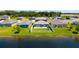 Backyard features a privacy fence, green grass, and pond views at 8656 40Th E Cir, Palmetto, FL 34221