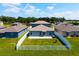 Backyard featuring a white fence, green grass, and a stone patio at 8656 40Th E Cir, Palmetto, FL 34221