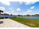 This backyard offers a peaceful pond view from the stone patio and grassy yard at 8656 40Th E Cir, Palmetto, FL 34221