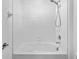 Bright bathroom features a white tiled shower and bathtub with a rainfall shower head at 8656 40Th E Cir, Palmetto, FL 34221