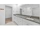 Bright bathroom featuring granite counters, dual sinks, a walk-in closet and shower at 8656 40Th E Cir, Palmetto, FL 34221