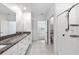Well-lit bathroom with granite countertops, double sinks, and a sleek, modern shower at 8656 40Th E Cir, Palmetto, FL 34221