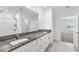 Bathroom featuring a double vanity with granite countertop and sleek fixtures at 8656 40Th E Cir, Palmetto, FL 34221