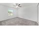 Clean bedroom with neutral walls, carpet, ceiling fan, and a view from the window at 8656 40Th E Cir, Palmetto, FL 34221