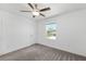 Cozy bedroom features a ceiling fan, neutral carpet and walls, and a bright window at 8656 40Th E Cir, Palmetto, FL 34221