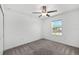 Bedroom featuring neutral walls and carpet, a ceiling fan, and a window with a pleasant view at 8656 40Th E Cir, Palmetto, FL 34221