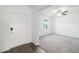 Bright entryway featuring new gray carpet, white walls, a modern ceiling fan, and a large window at 8656 40Th E Cir, Palmetto, FL 34221