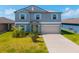 Two-story home with a blue exterior, light shutters, a two-car garage, and a well-manicured lawn at 8656 40Th E Cir, Palmetto, FL 34221