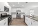 Modern kitchen with white cabinets, stainless steel appliances, and stone countertops at 8656 40Th E Cir, Palmetto, FL 34221