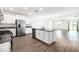 Open kitchen layout with a center island, stone countertops, and stainless steel appliances at 8656 40Th E Cir, Palmetto, FL 34221