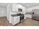 Modern kitchen with white cabinets, stainless steel appliances, and stone countertops at 8656 40Th E Cir, Palmetto, FL 34221