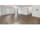 Open-concept living room featuring modern flooring and sliding doors to outdoor area at 8656 40Th E Cir, Palmetto, FL 34221