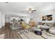 Open-concept living room with dining area and stylish furnishings under a ceiling fan at 8656 40Th E Cir, Palmetto, FL 34221