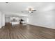 Open-concept living room with adjacent modern kitchen under a ceiling fan at 8656 40Th E Cir, Palmetto, FL 34221