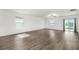 Bright living room with wood-look floors, large windows and sliding glass doors leading to the outside at 8656 40Th E Cir, Palmetto, FL 34221
