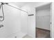Modern tiled shower with convenient shelving and a view of the walk-in closet at 8656 40Th E Cir, Palmetto, FL 34221