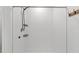 Modern tiled shower with black fixtures and built-in shelving for convenient storage at 8656 40Th E Cir, Palmetto, FL 34221