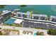Aerial view of condos, tennis courts and recreational area with bay access at 8897 Midnight Pass Rd # 407, Sarasota, FL 34242