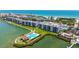 Beautiful aerial view of the condo building, pool, and Intracoastal waterway with beach access in the distance at 8897 Midnight Pass Rd # 407, Sarasota, FL 34242