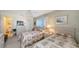 Cozy bedroom featuring two twin beds, neutral tones, and access to a full ensuite bathroom at 8897 Midnight Pass Rd # 407, Sarasota, FL 34242