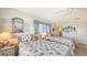 Bright bedroom with twin beds, side tables with lamps, neutral carpet and calming atmosphere at 8897 Midnight Pass Rd # 407, Sarasota, FL 34242