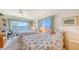 Bedroom with twin beds, bright natural light and views of the bay at 8897 Midnight Pass Rd # 407, Sarasota, FL 34242
