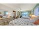 Bedroom with twin beds, side tables, built-in desk, and views of the intercoastal at 8897 Midnight Pass Rd # 407, Sarasota, FL 34242